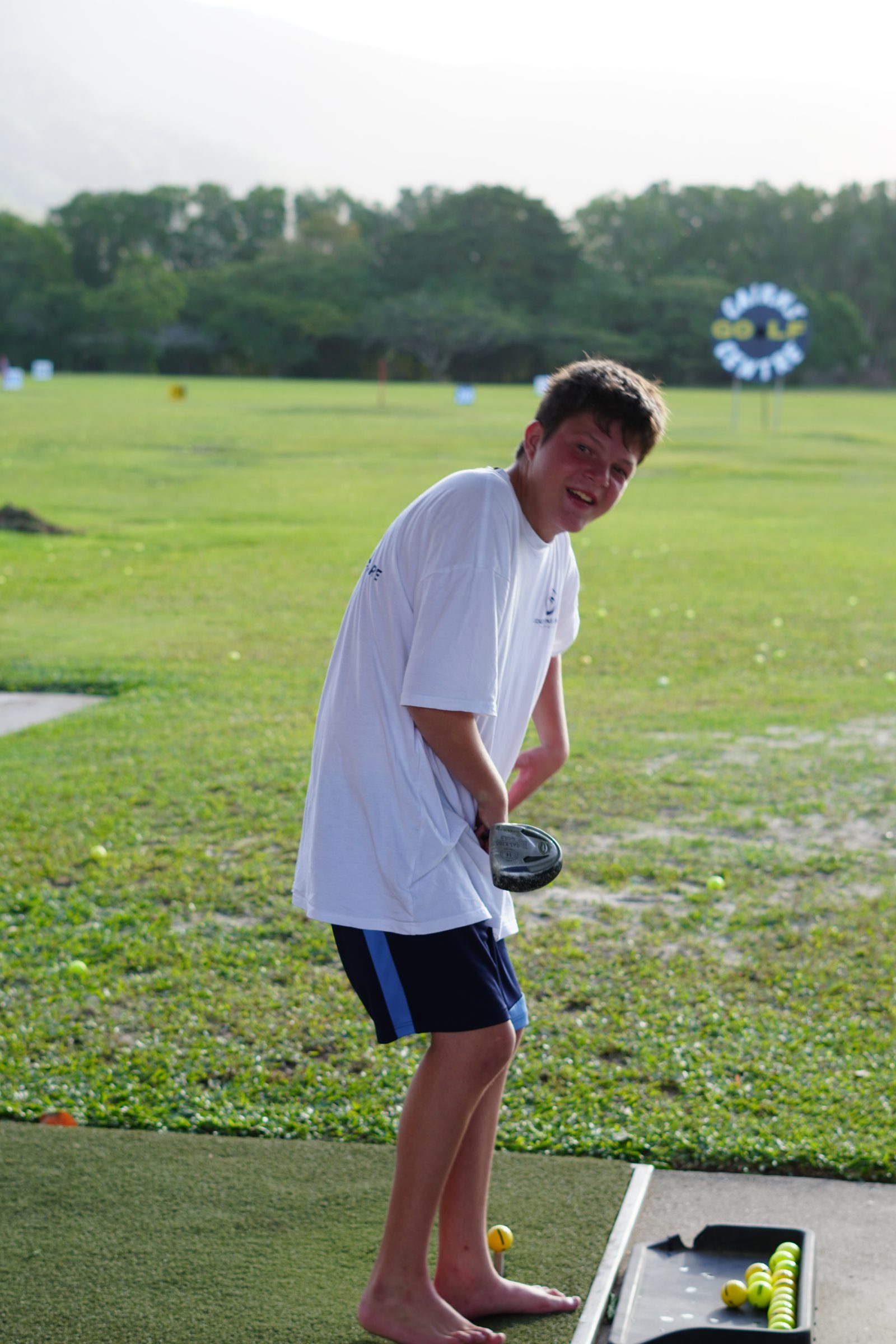 A young person at a Cairns driving range during a one-to-one session