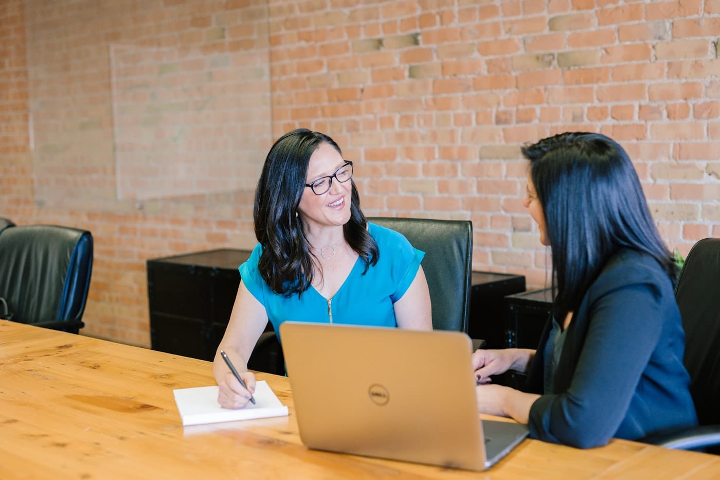 Two support professionals talking through a referral